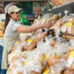 smiling bakery associate in supermarket