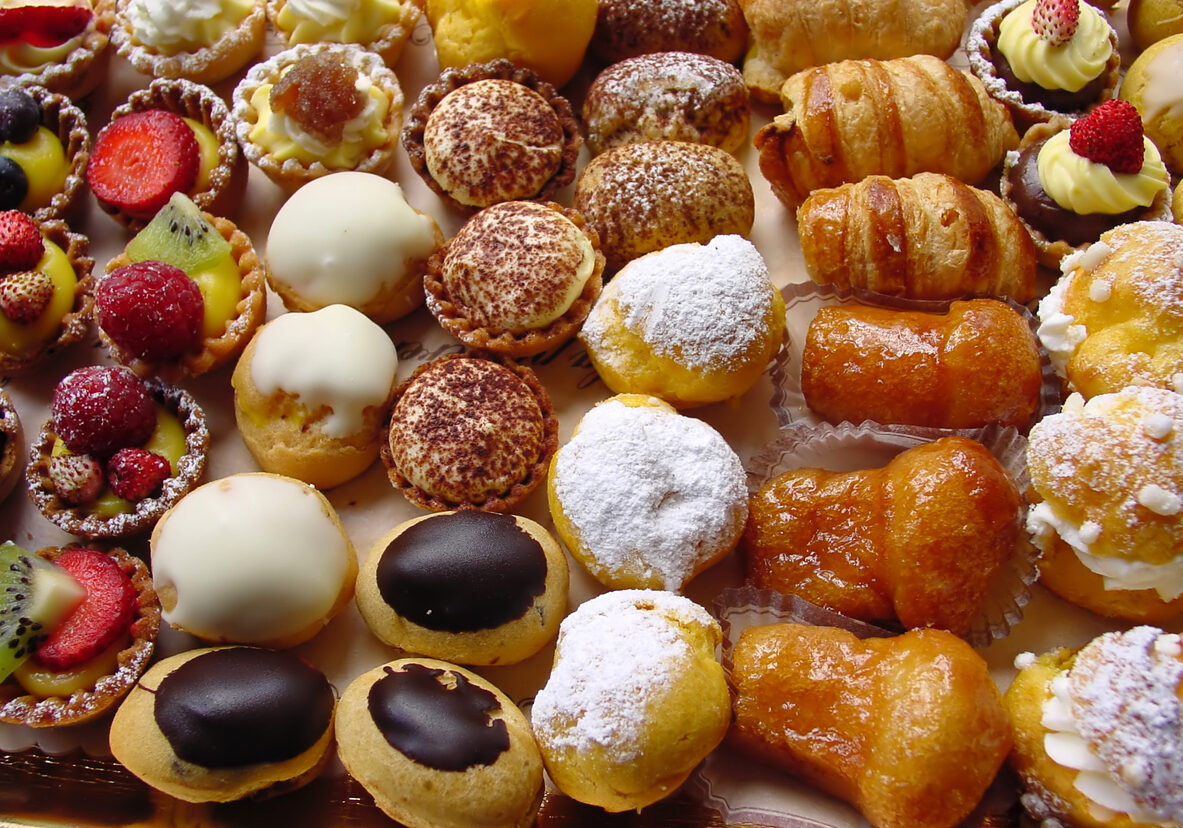 close-up of fresh italian pastries with cream and fruit