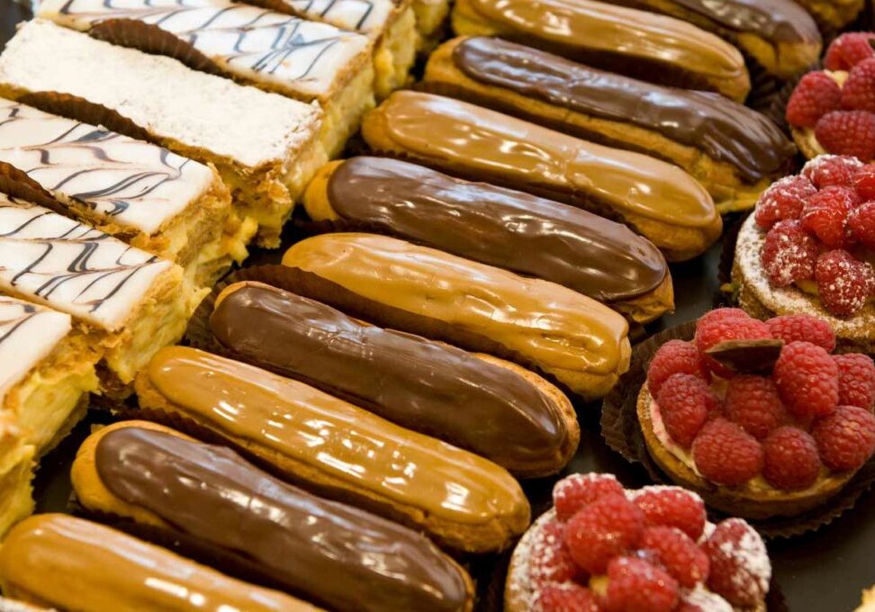 assorted pastries chocolate and caramel eclairs raspberry tarts and napoleons